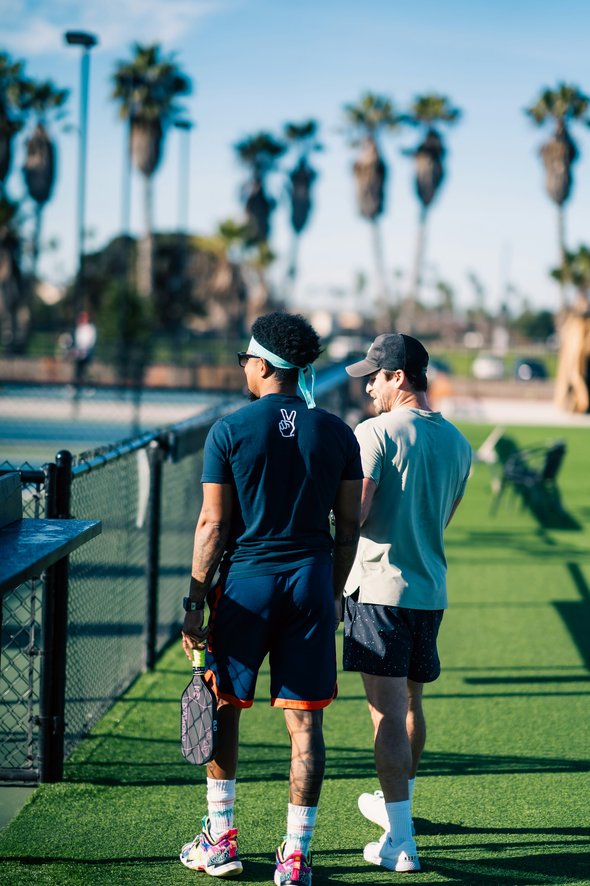 A couple of men standing on top of a lush green field