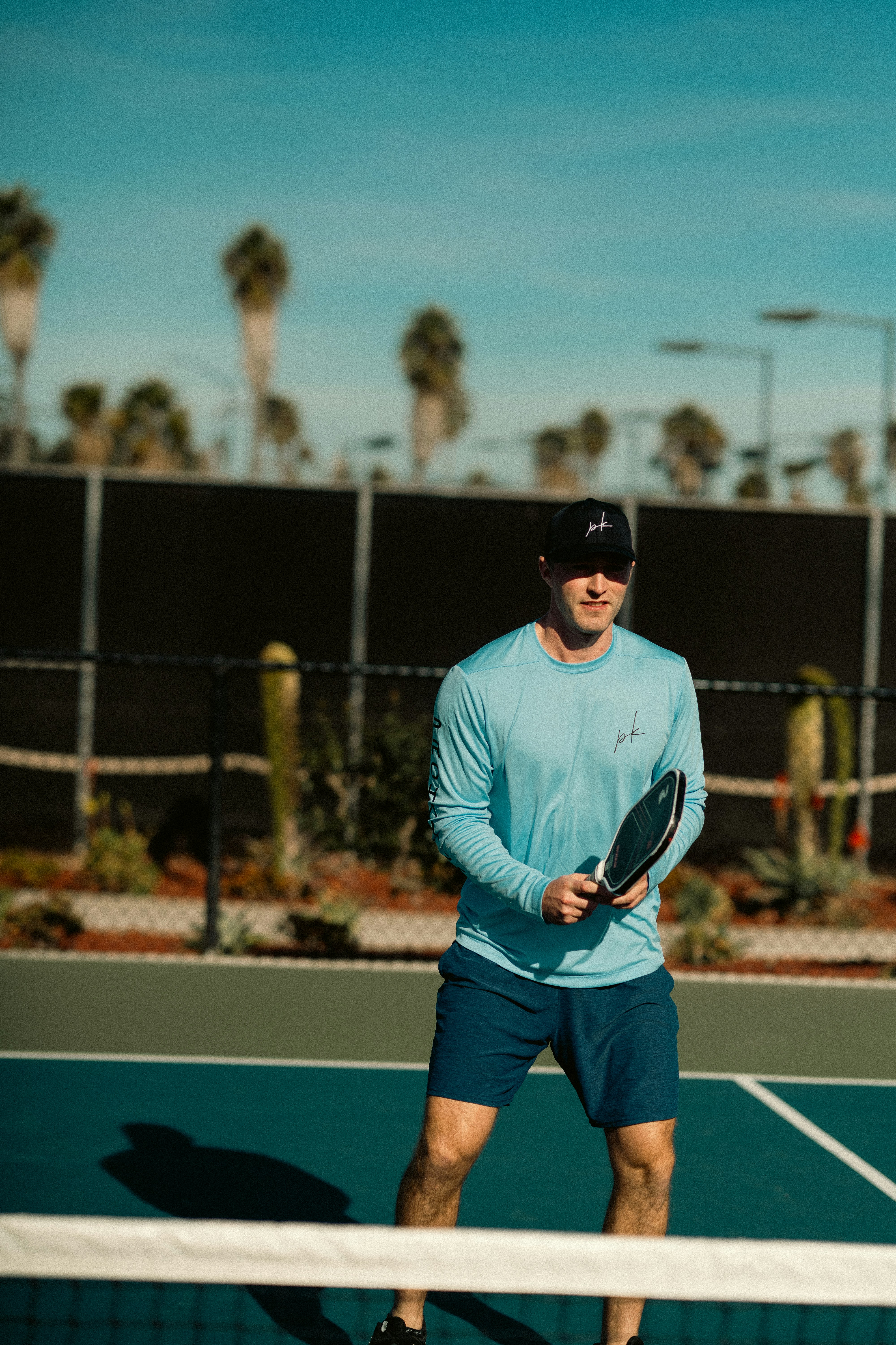 A man standing on a tennis court holding a racquet