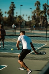 A man standing on a tennis court holding a racquet