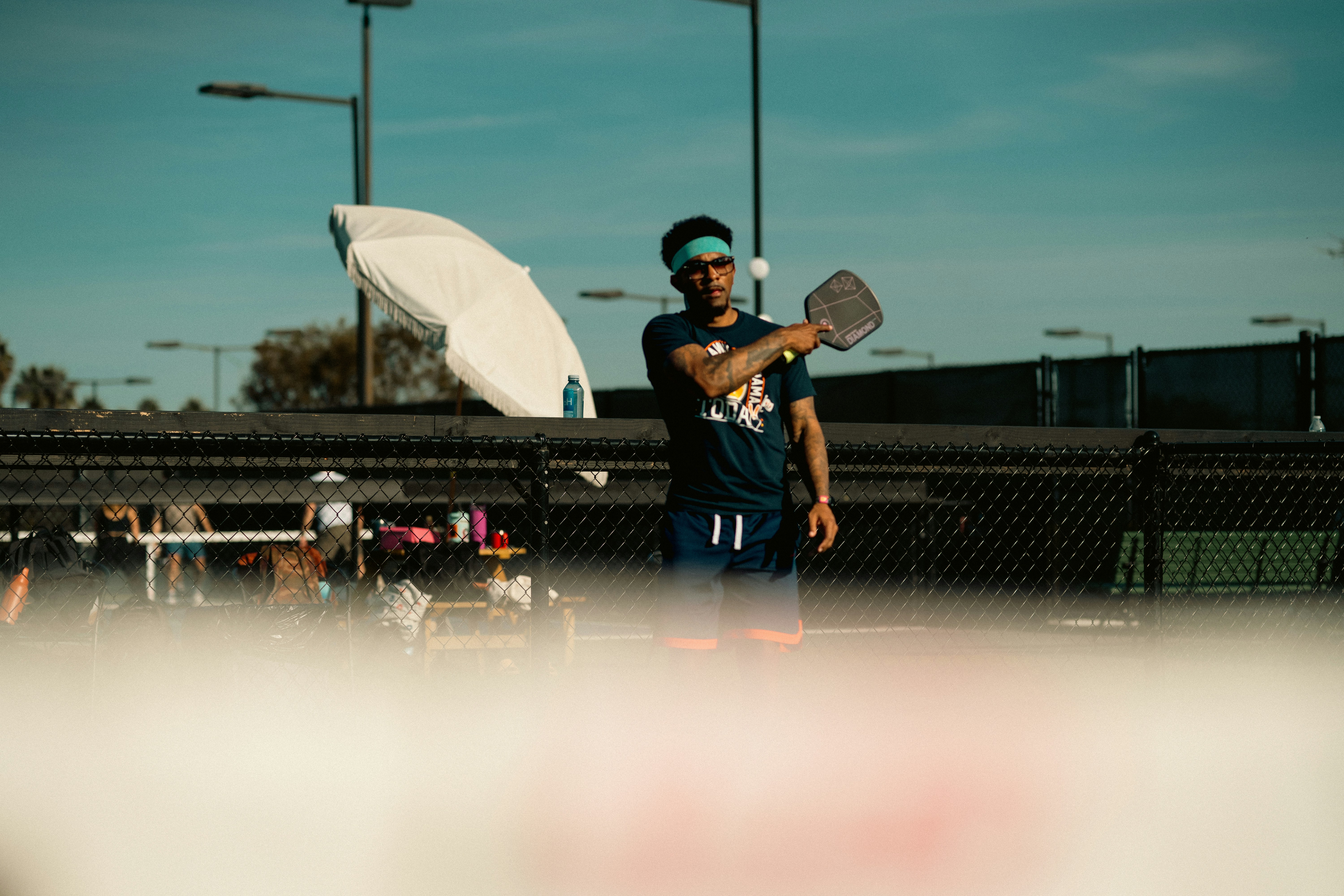 A man holding a tennis racquet on top of a tennis court