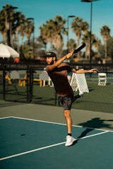 A man swinging a tennis racquet on a tennis court