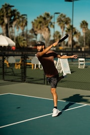 A man swinging a tennis racquet on a tennis court