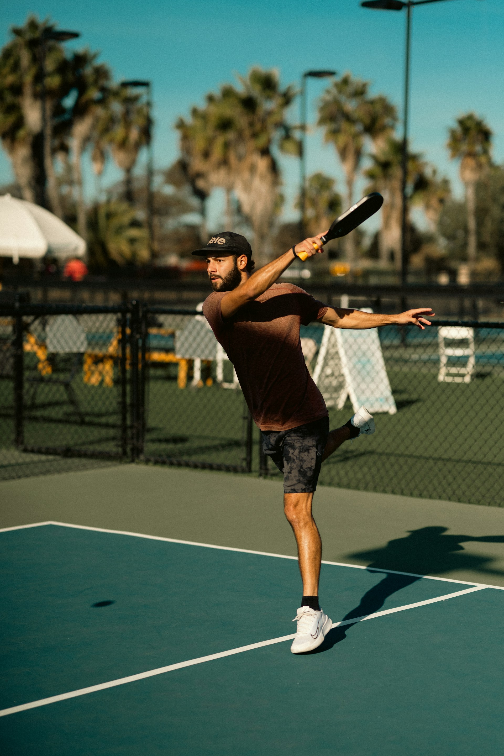 A man swinging a tennis racquet on a tennis court