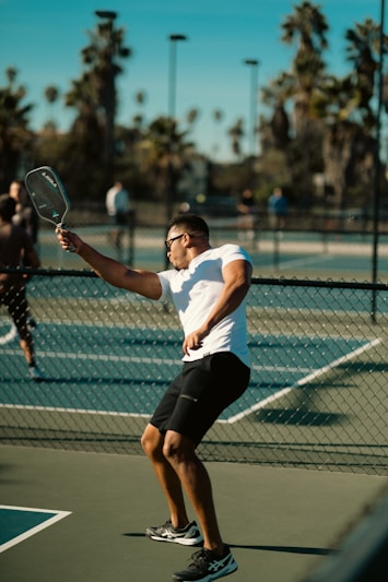 A man holding a tennis racquet on a tennis court