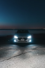 A car parked on the side of the road at night