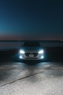 A car parked on the side of the road at night