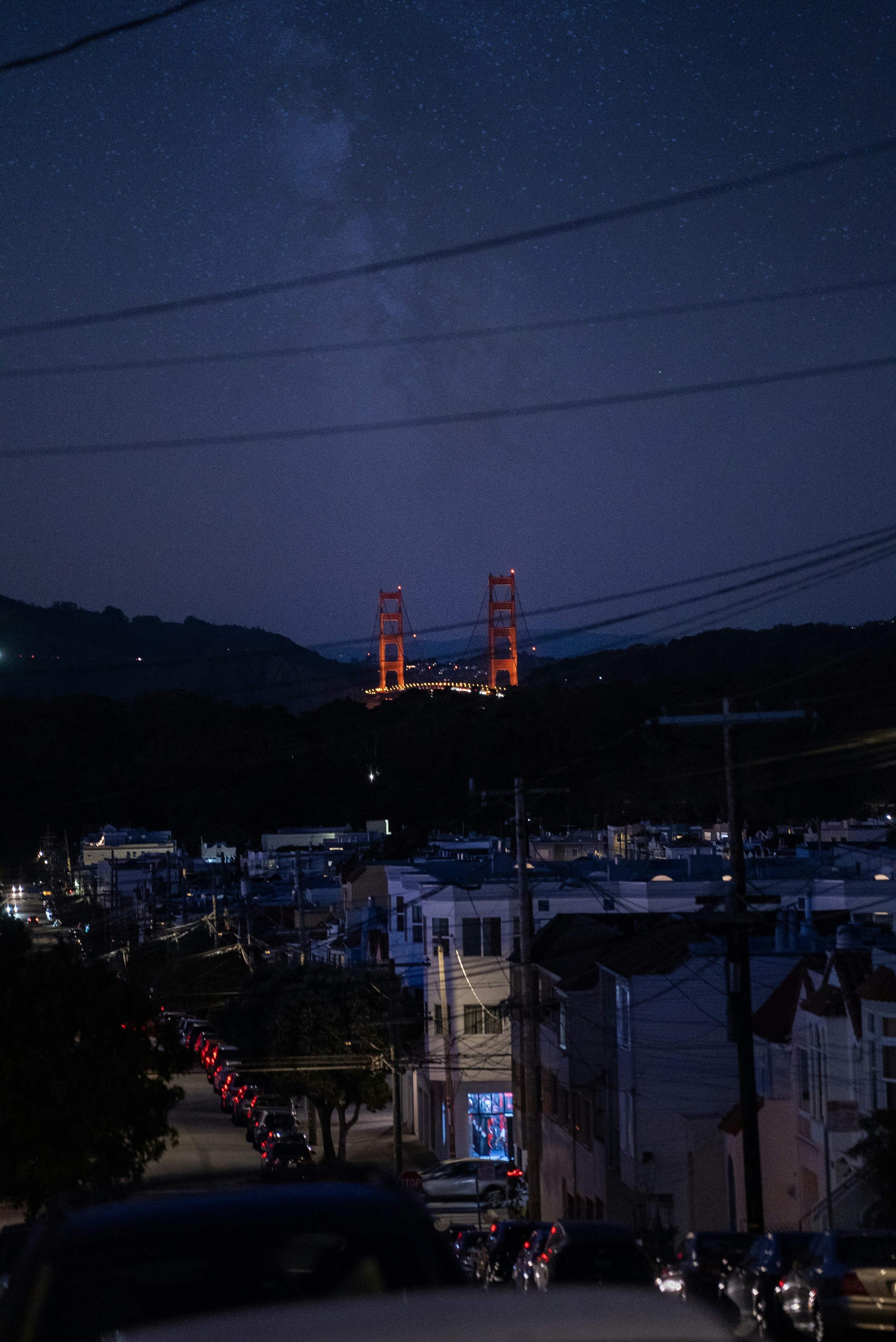 A view of a city at night from a hill