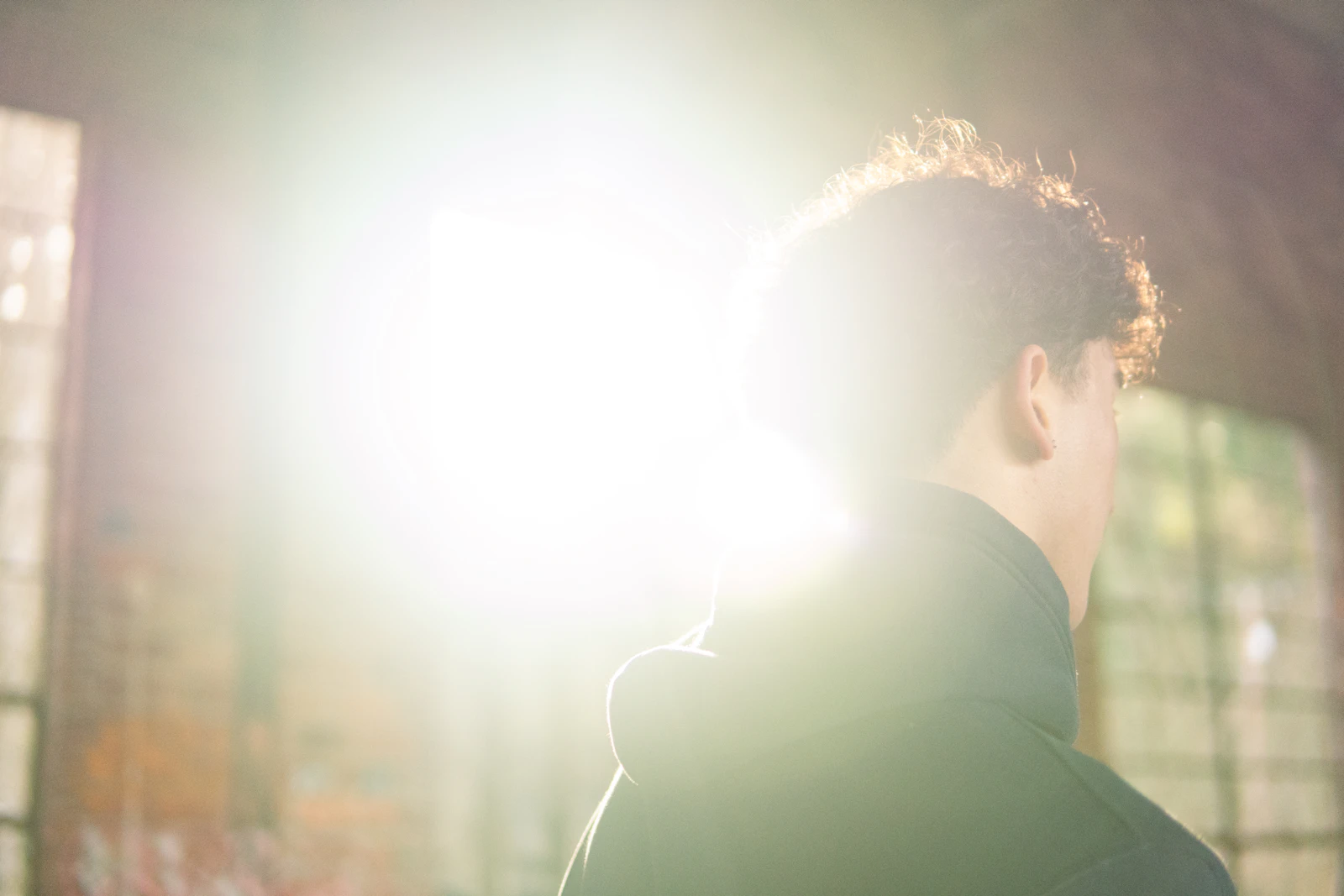 Backlit portrait beside a bright window