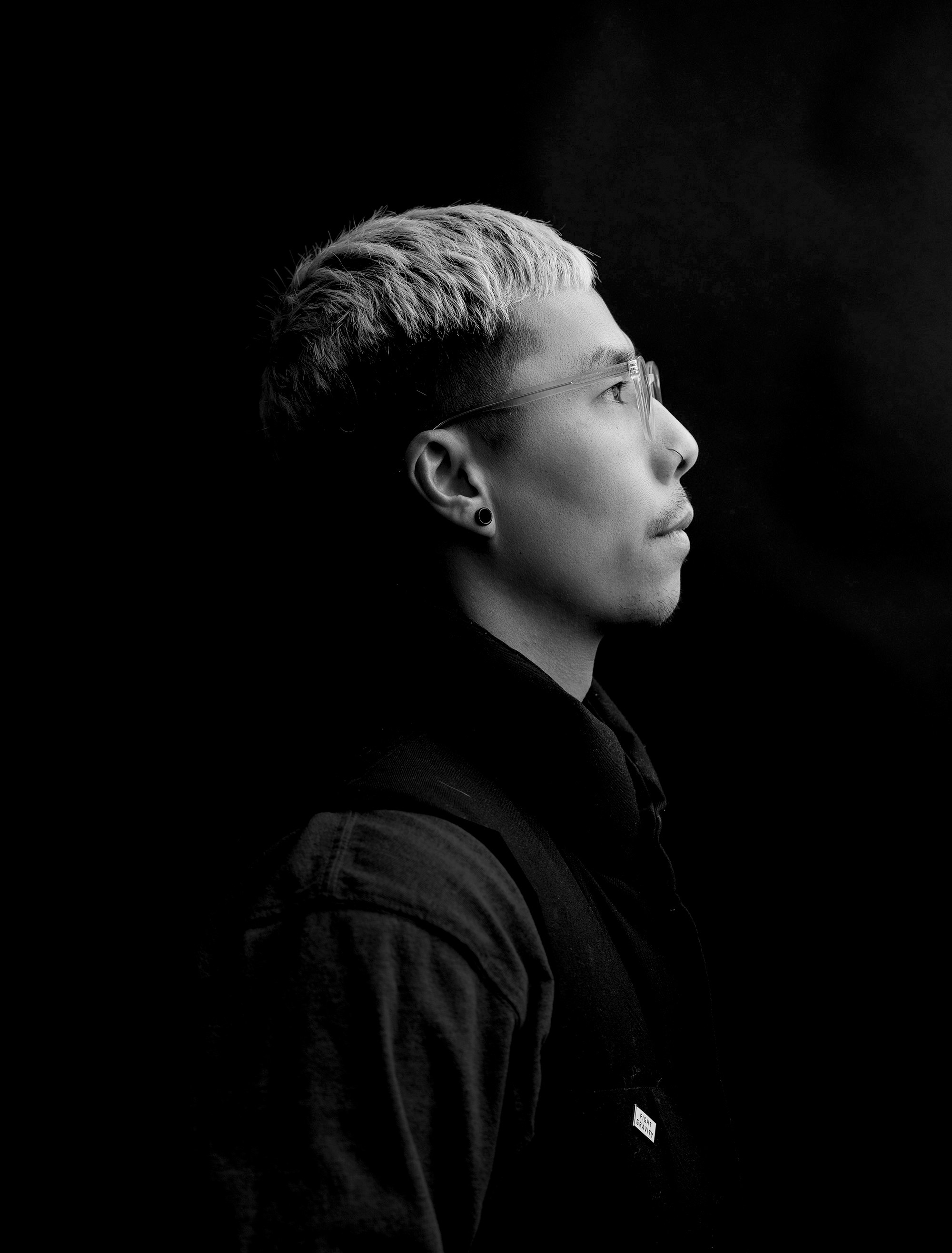 A black and white photo of a person wearing glasses