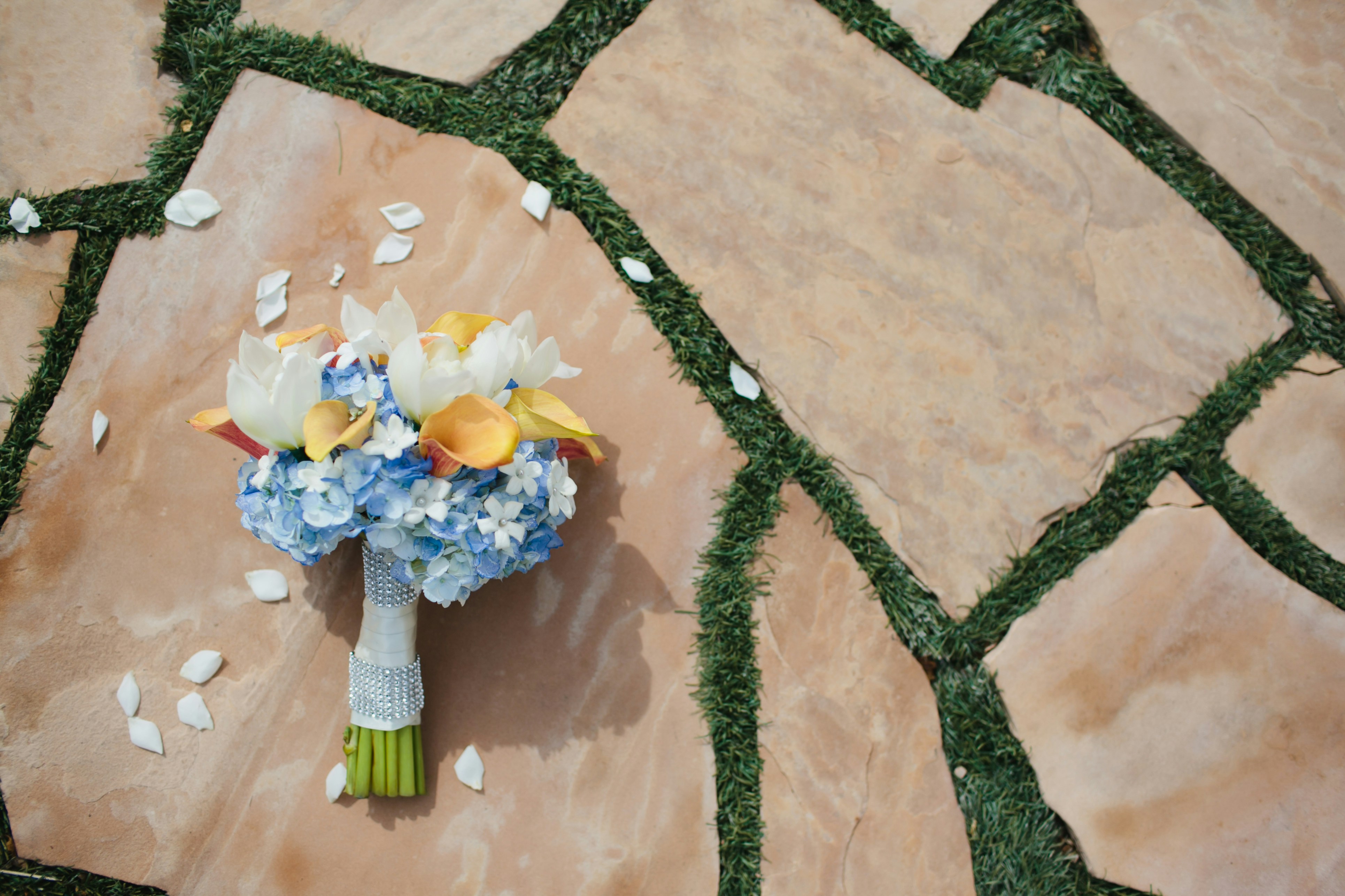 A bouquet of flowers sitting on top of a tiled floor