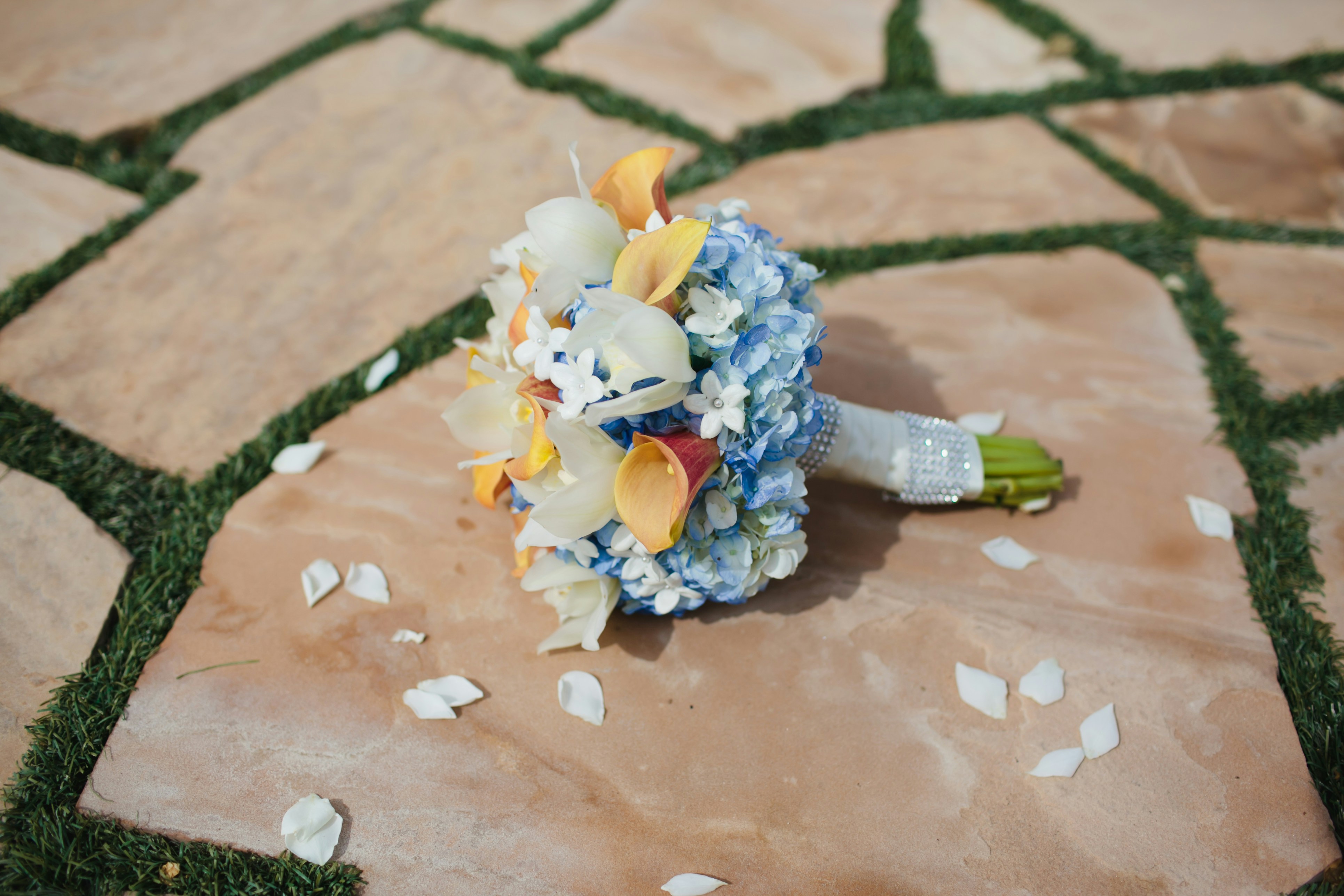 A bouquet of flowers sitting on the ground