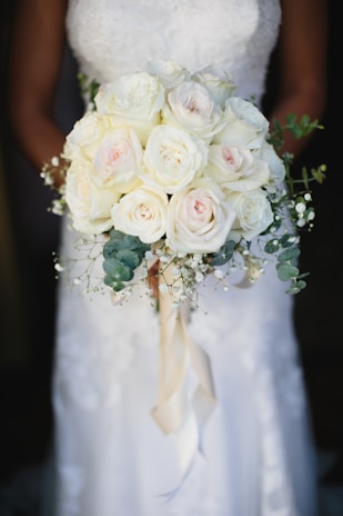 A bride holding a bouquet of white flowers