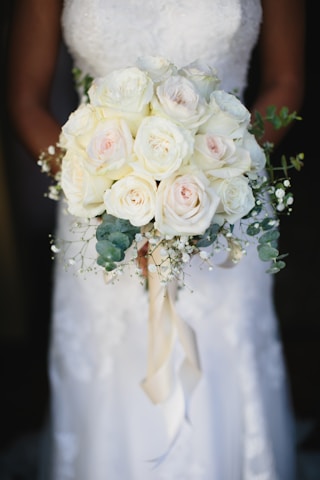 A bride holding a bouquet of white flowers