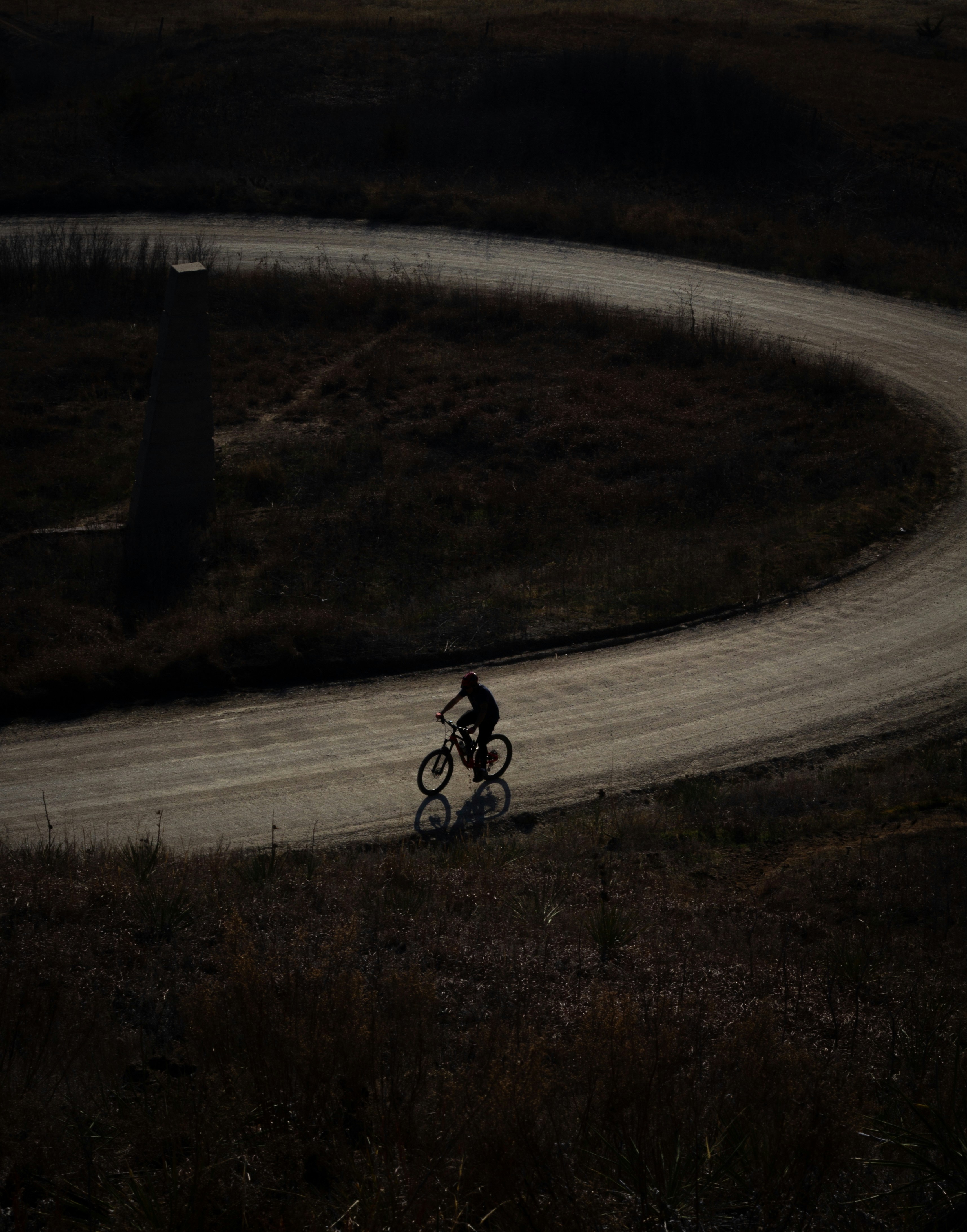 A man riding a bike down a curvy road