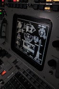 The control panel of a plane with a lot of buttons