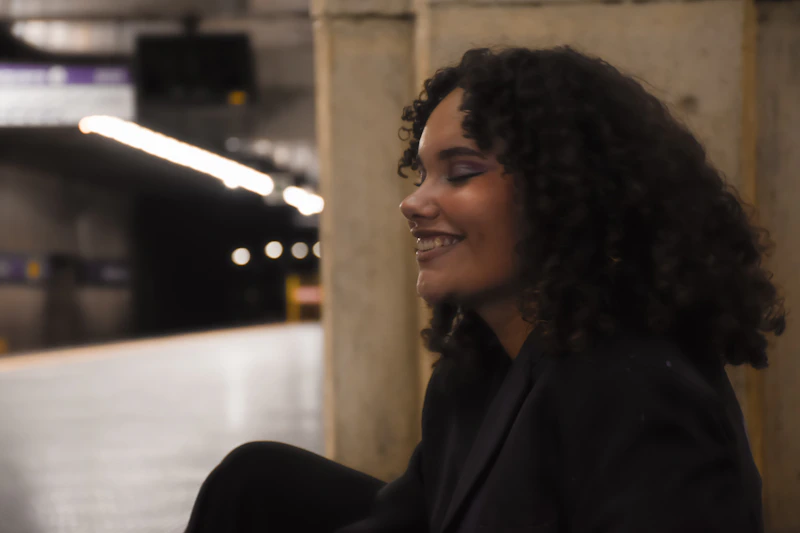 Woman sitting on a subway station bench