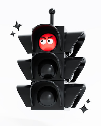 A traffic light with a red ball on top of it