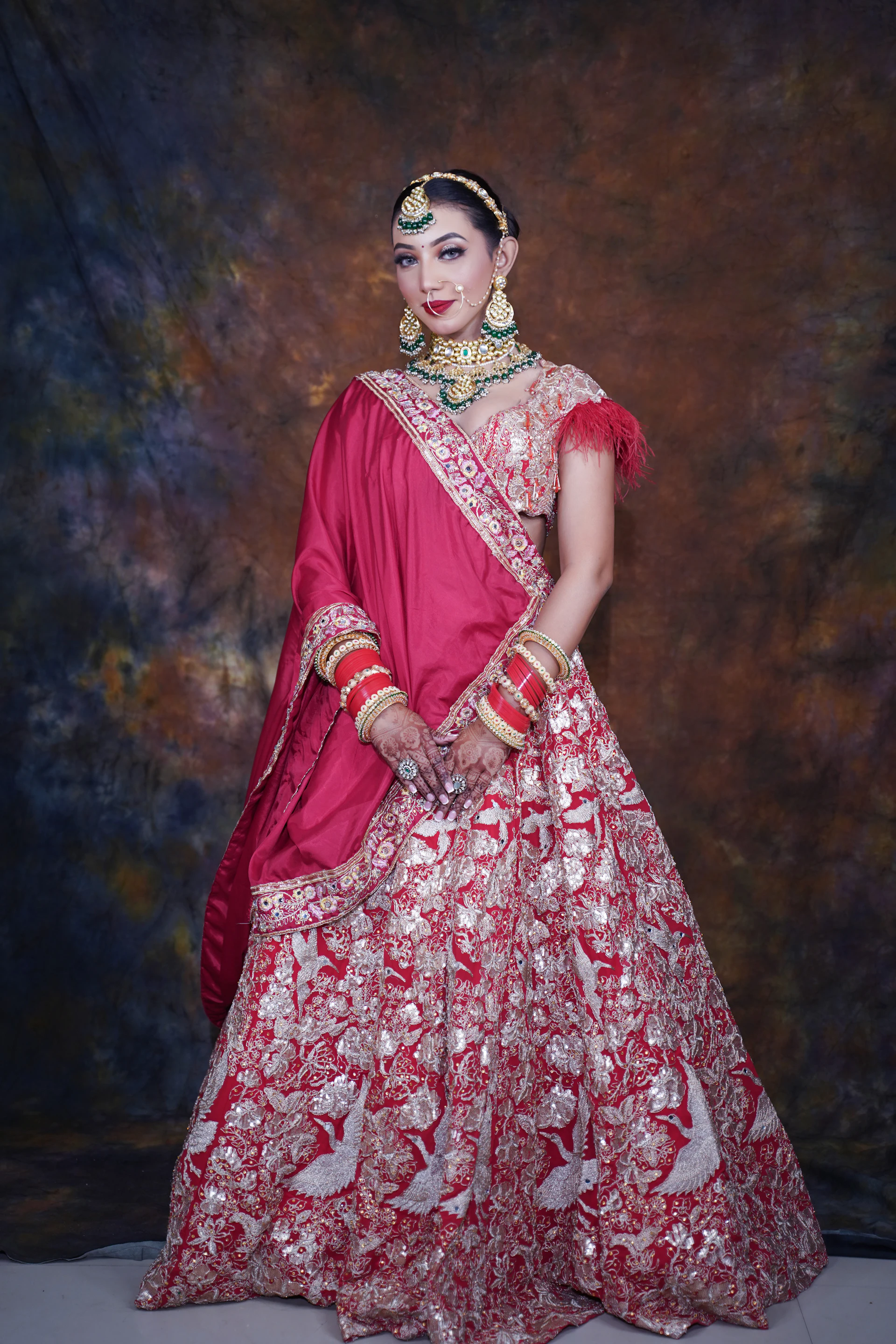 Bride in red and ivory bridal gown