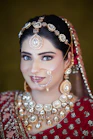 A woman in a red and gold bridal outfit