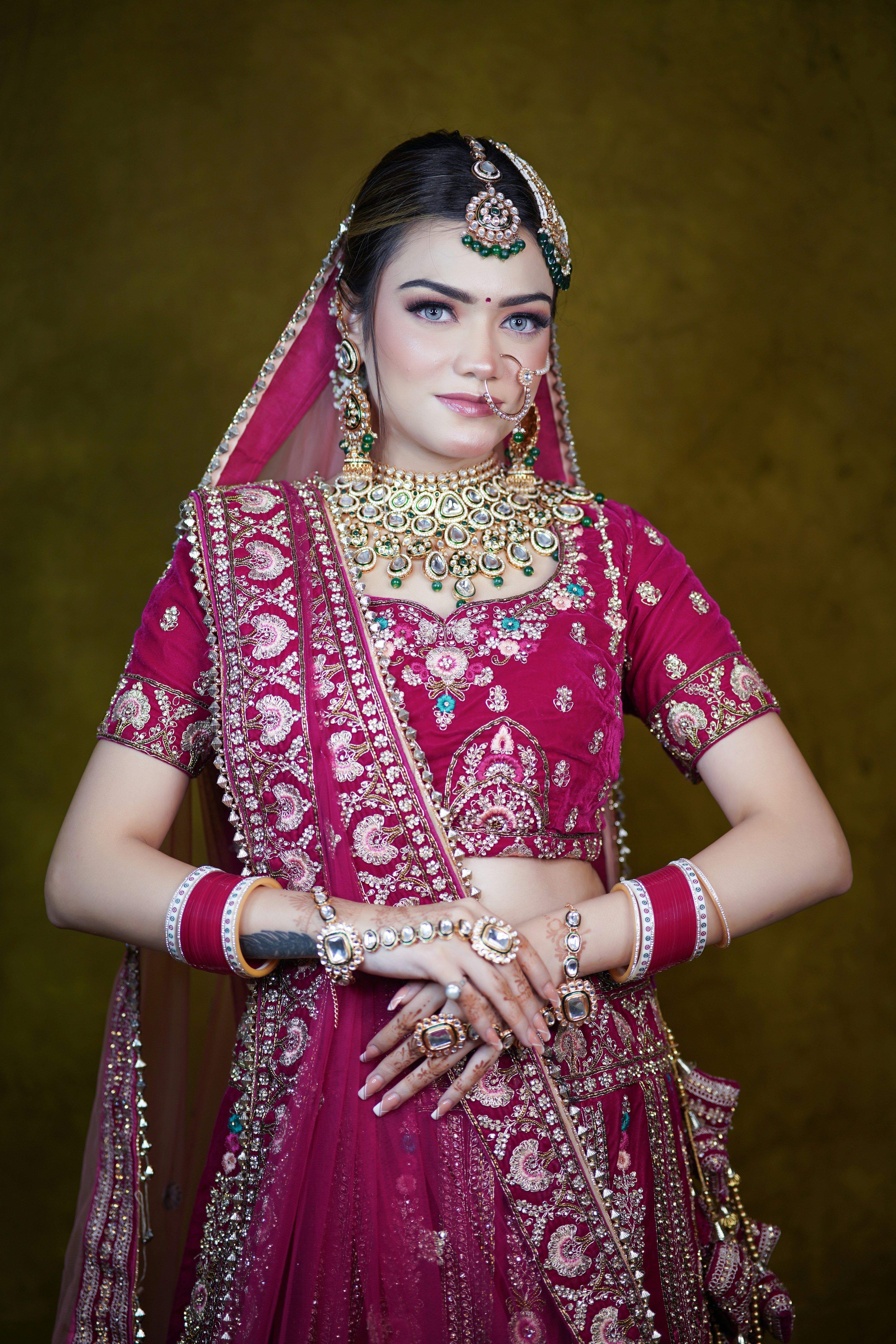 A woman in a red and gold bridal outfit