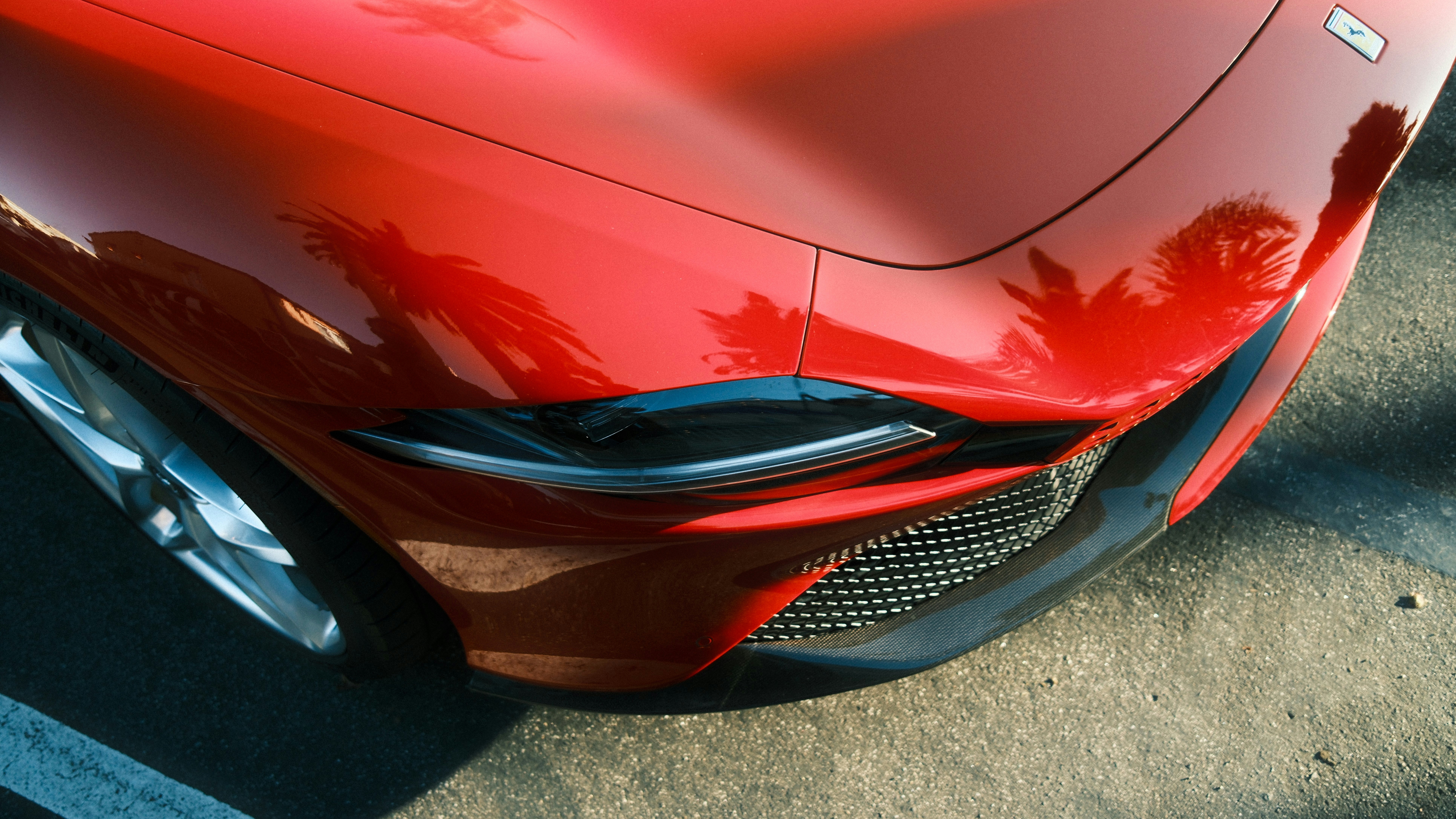 A close up of the front of a red sports car