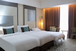 A hotel room with two beds and a large mirror