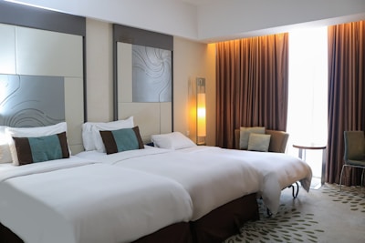 A hotel room with two beds and a large mirror