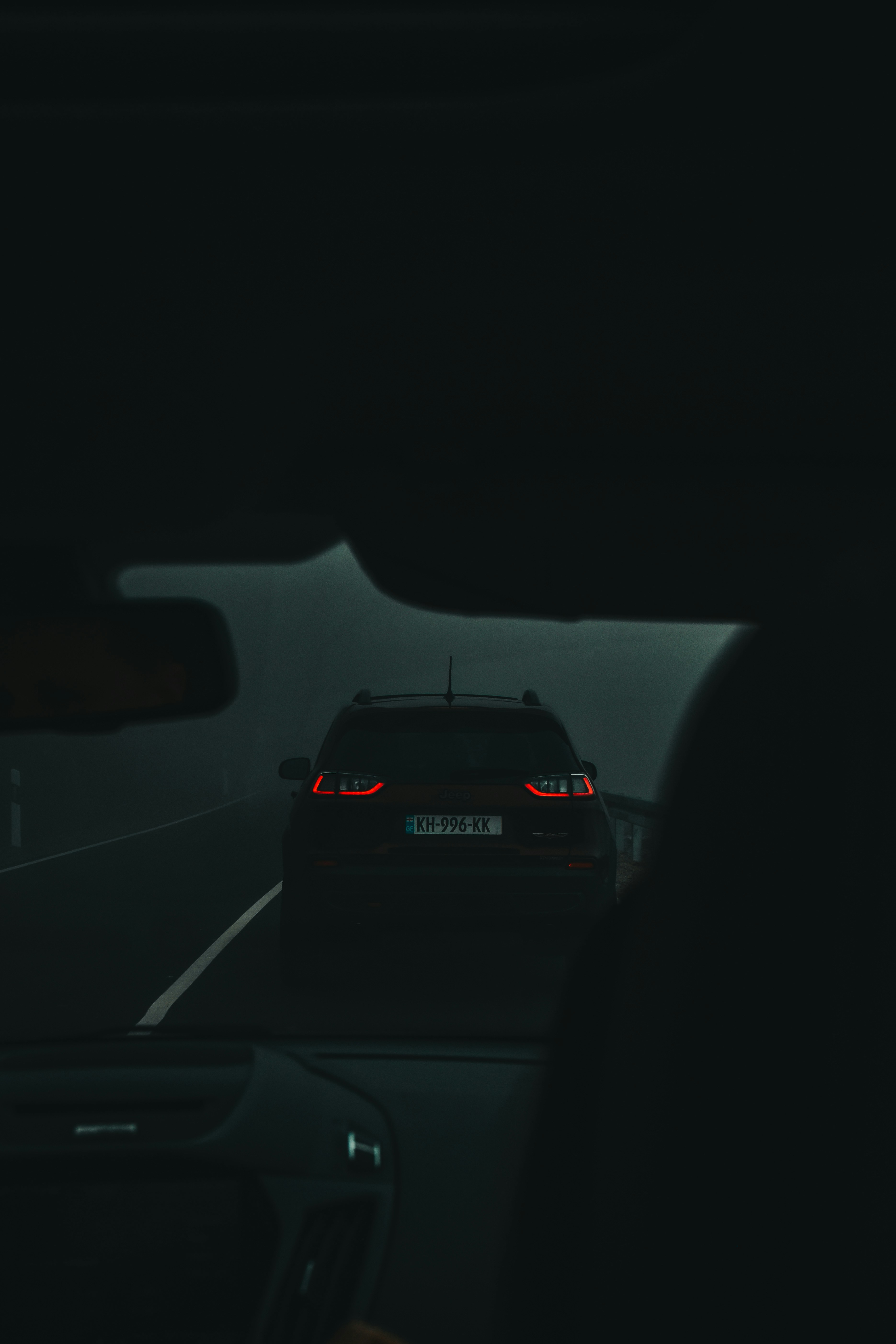 A car driving down a highway at night