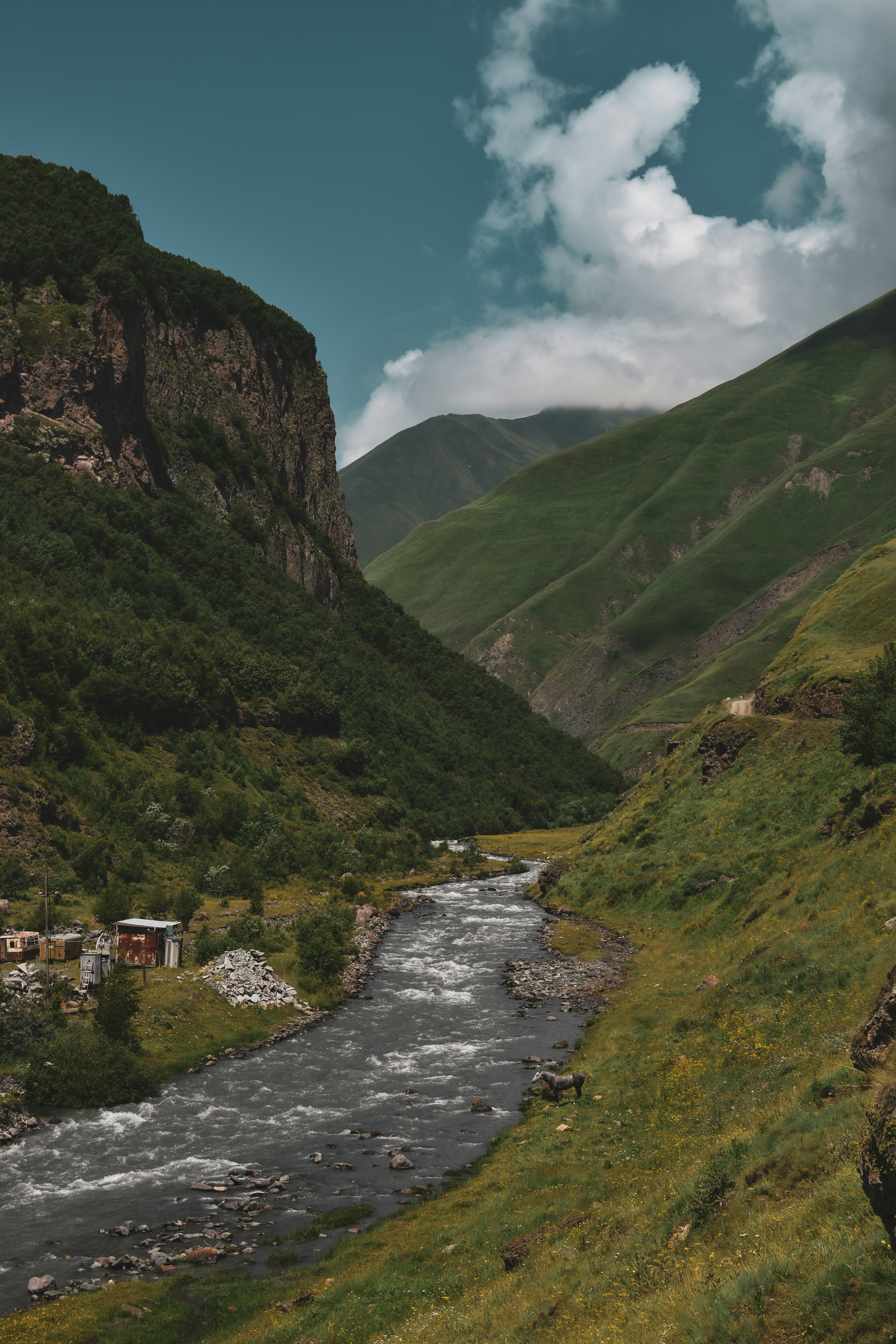 A river running through a lush green valley
