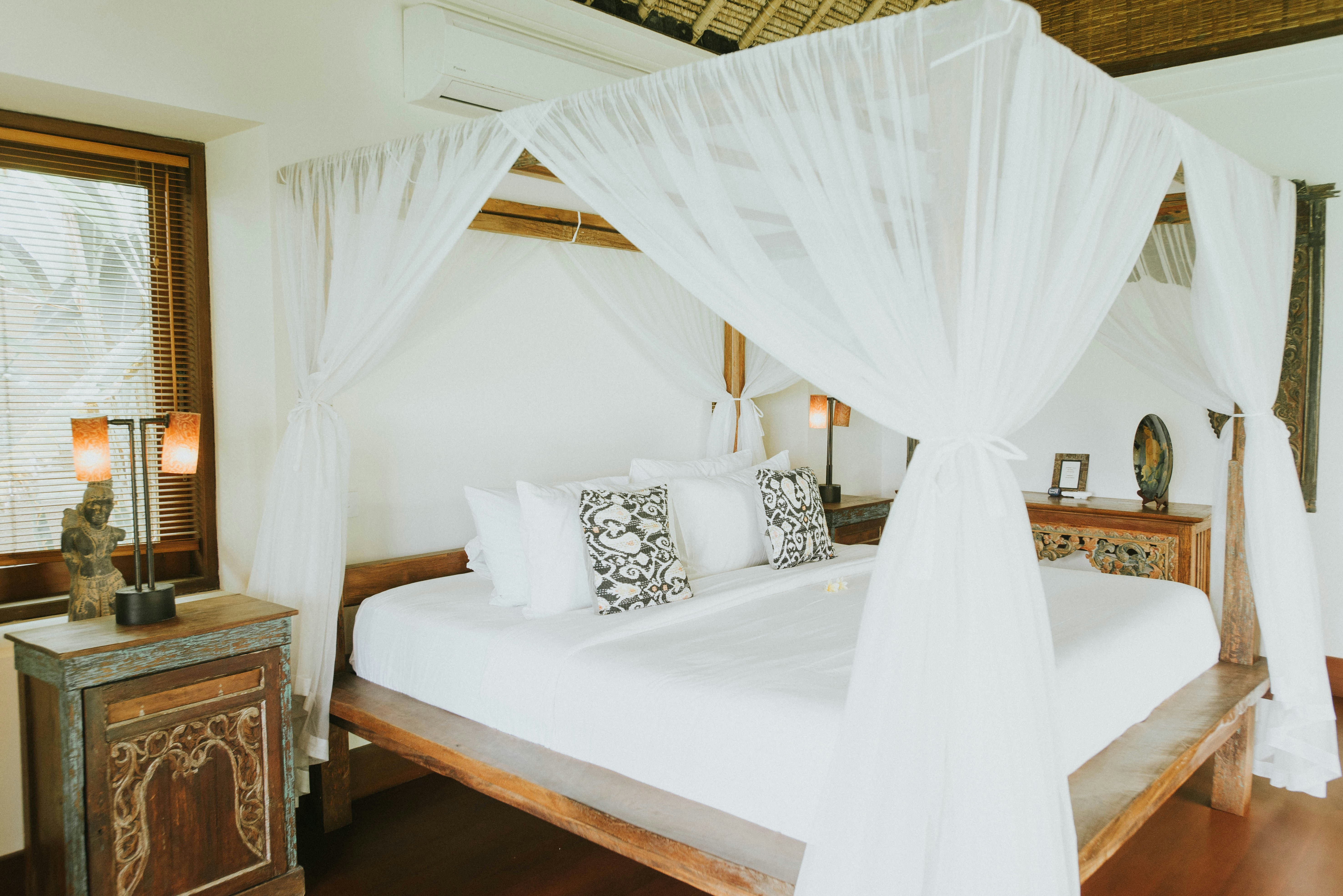 A bed with a white canopy over it