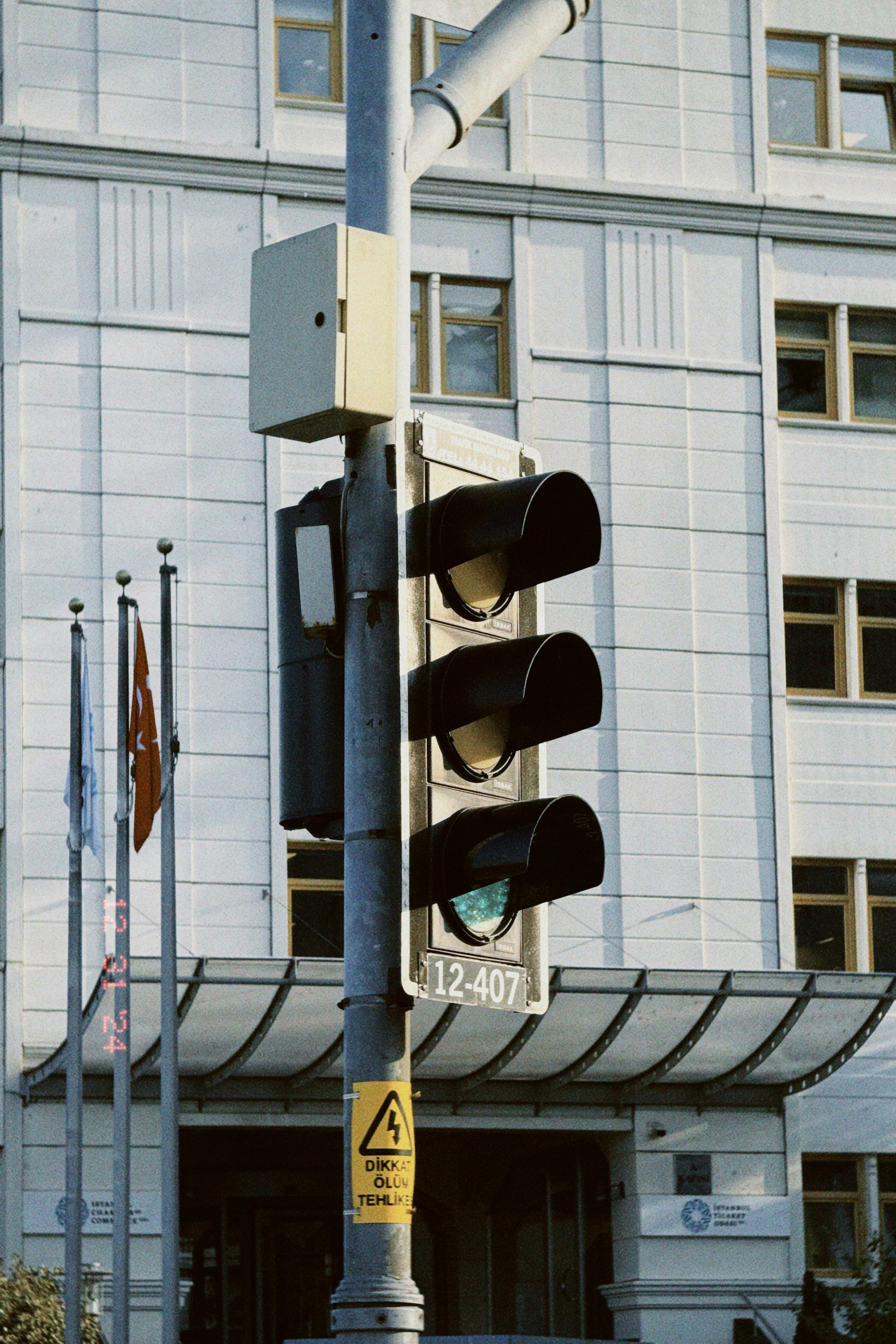 A traffic light sitting in front of a tall building