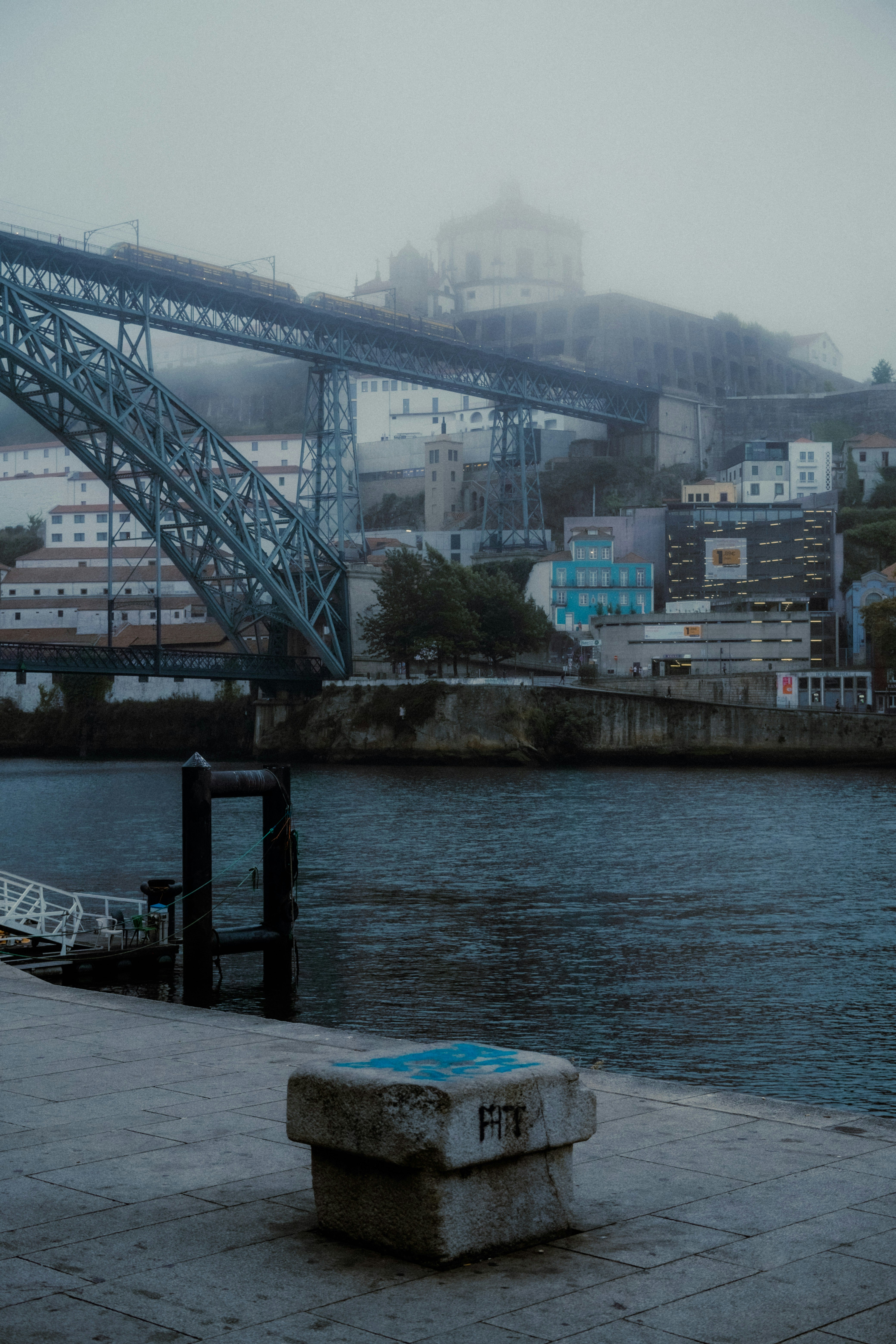 A bridge over a body of water with a city in the background