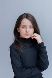 A young girl is posing for a picture