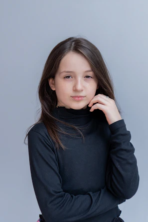 A young girl is posing for a picture