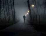 A person walking down a path in the dark