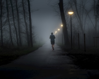 A person walking down a path in the dark