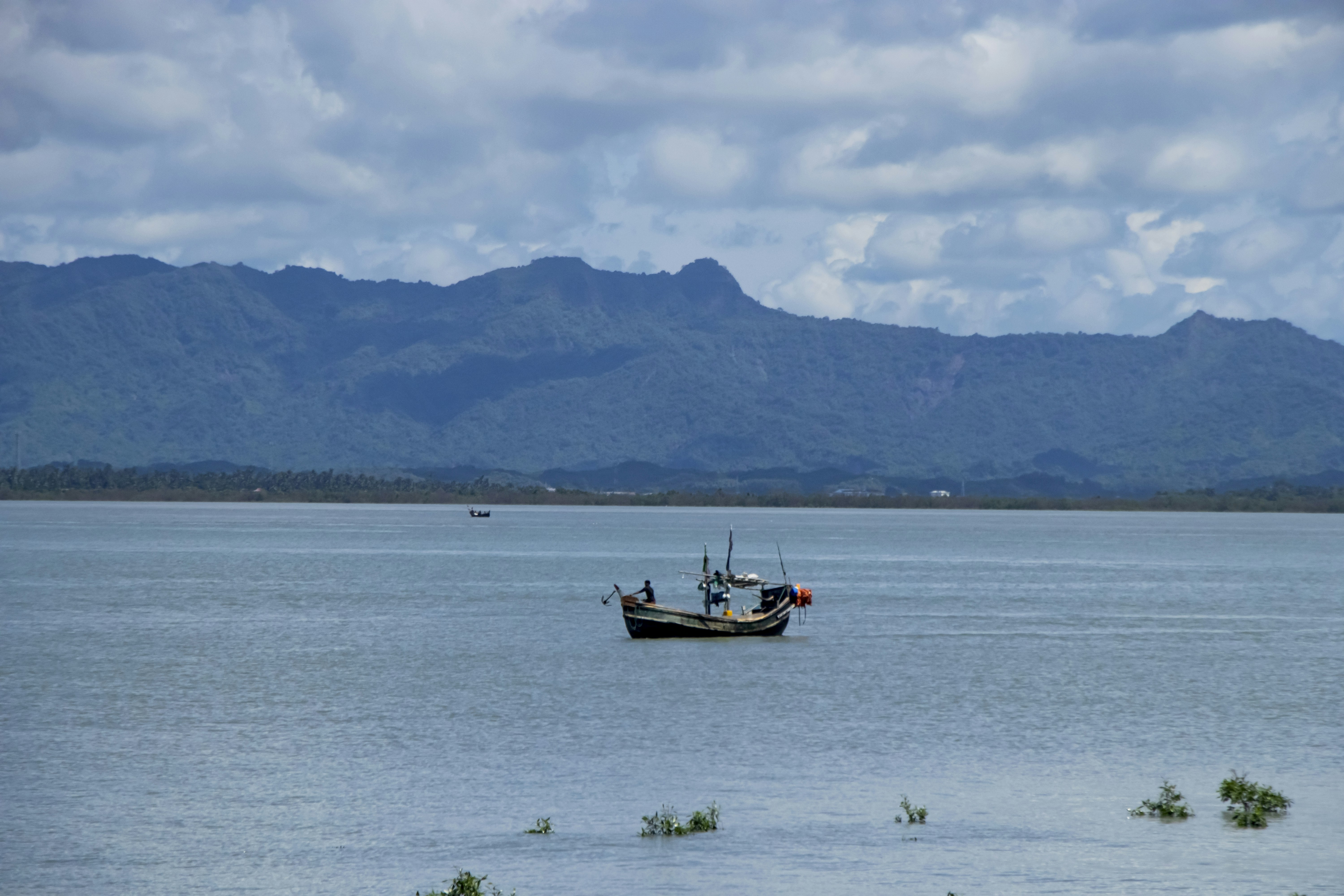 A boat floating on top of a large body of water