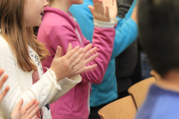 Children clapping and learning in a classroom