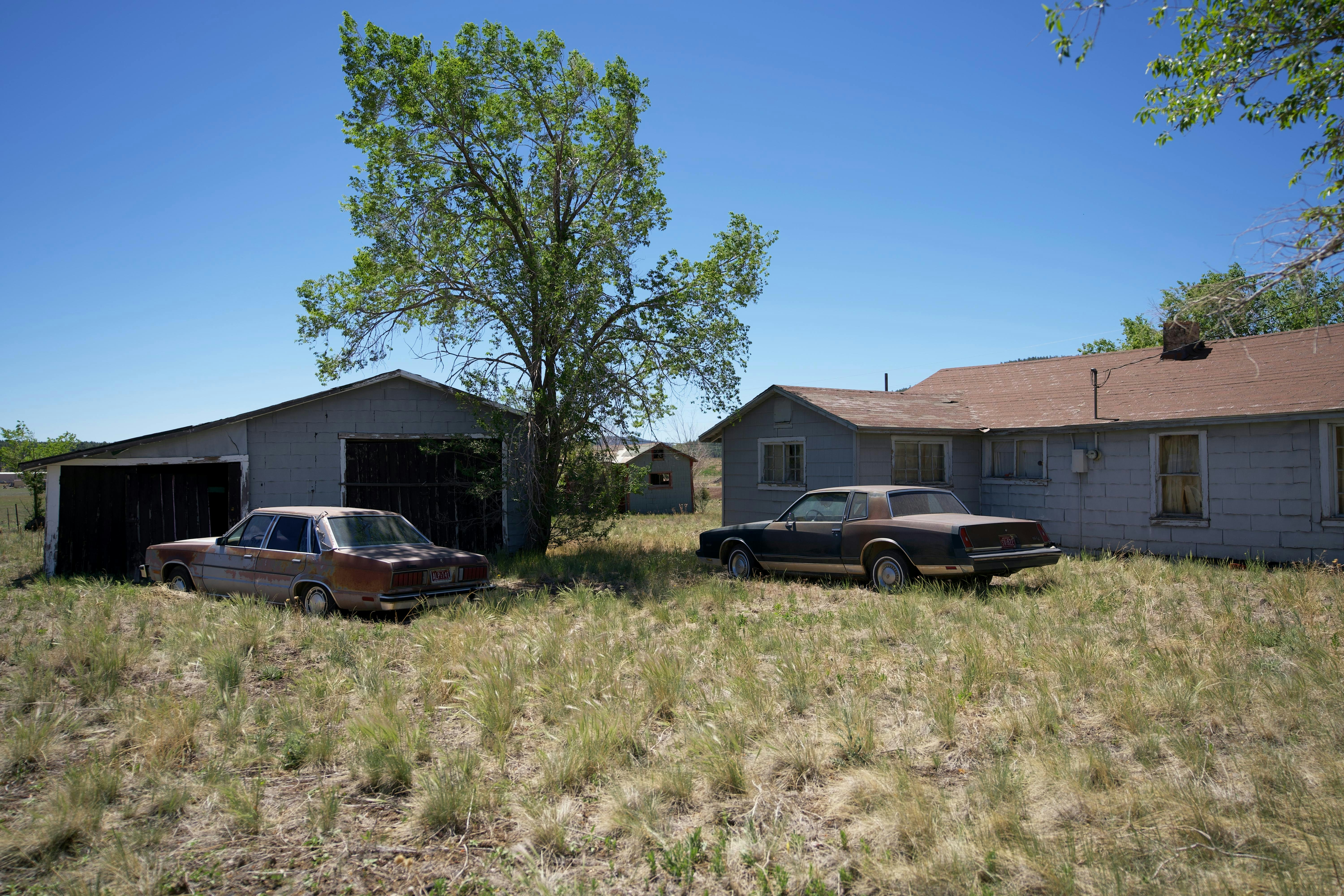 Two cars parked in front of a house