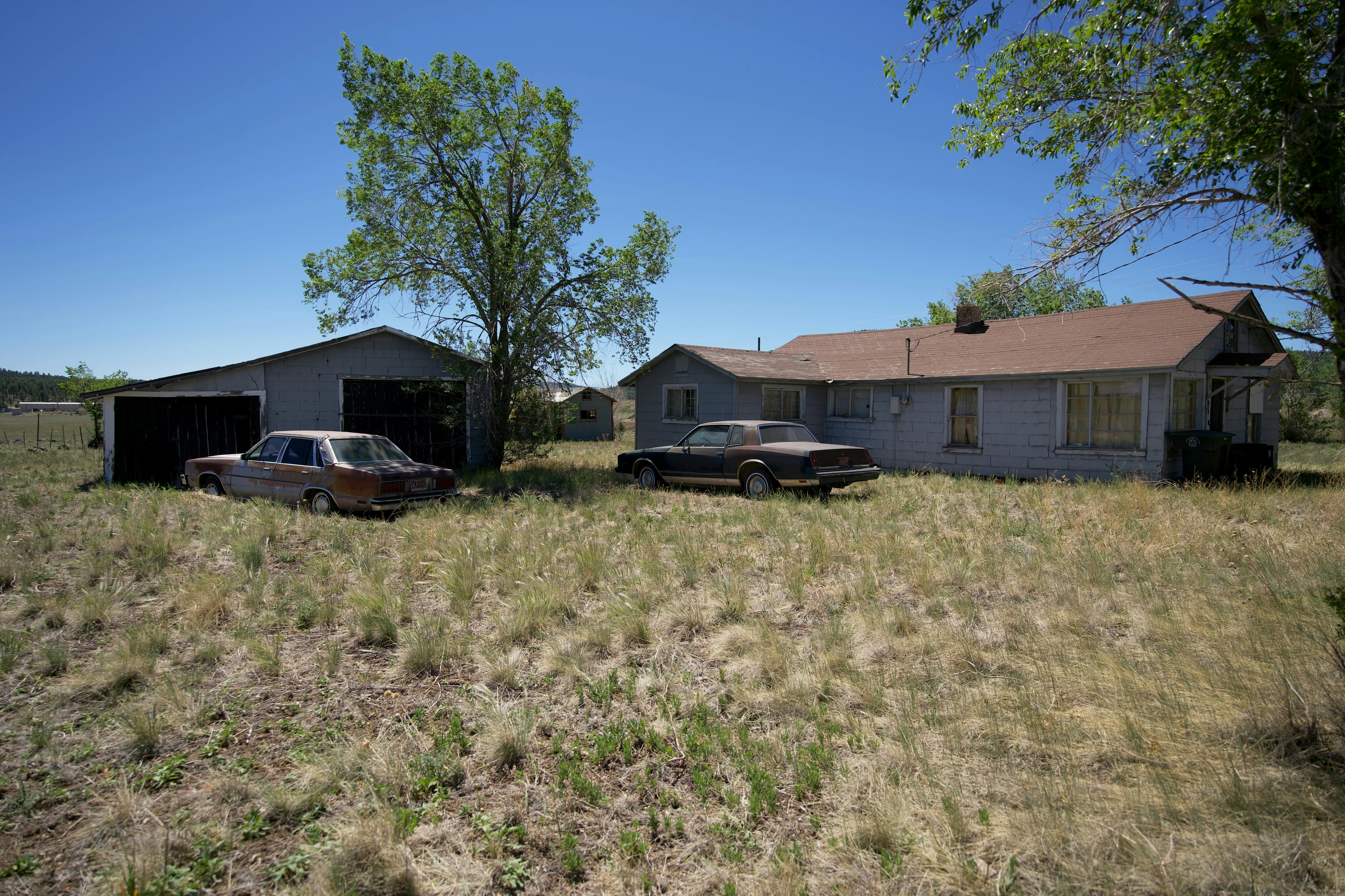 Two cars parked in front of a house