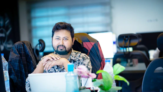 A man sitting in front of a laptop computer