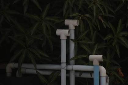 A close up of pipes and pipes in front of a tree