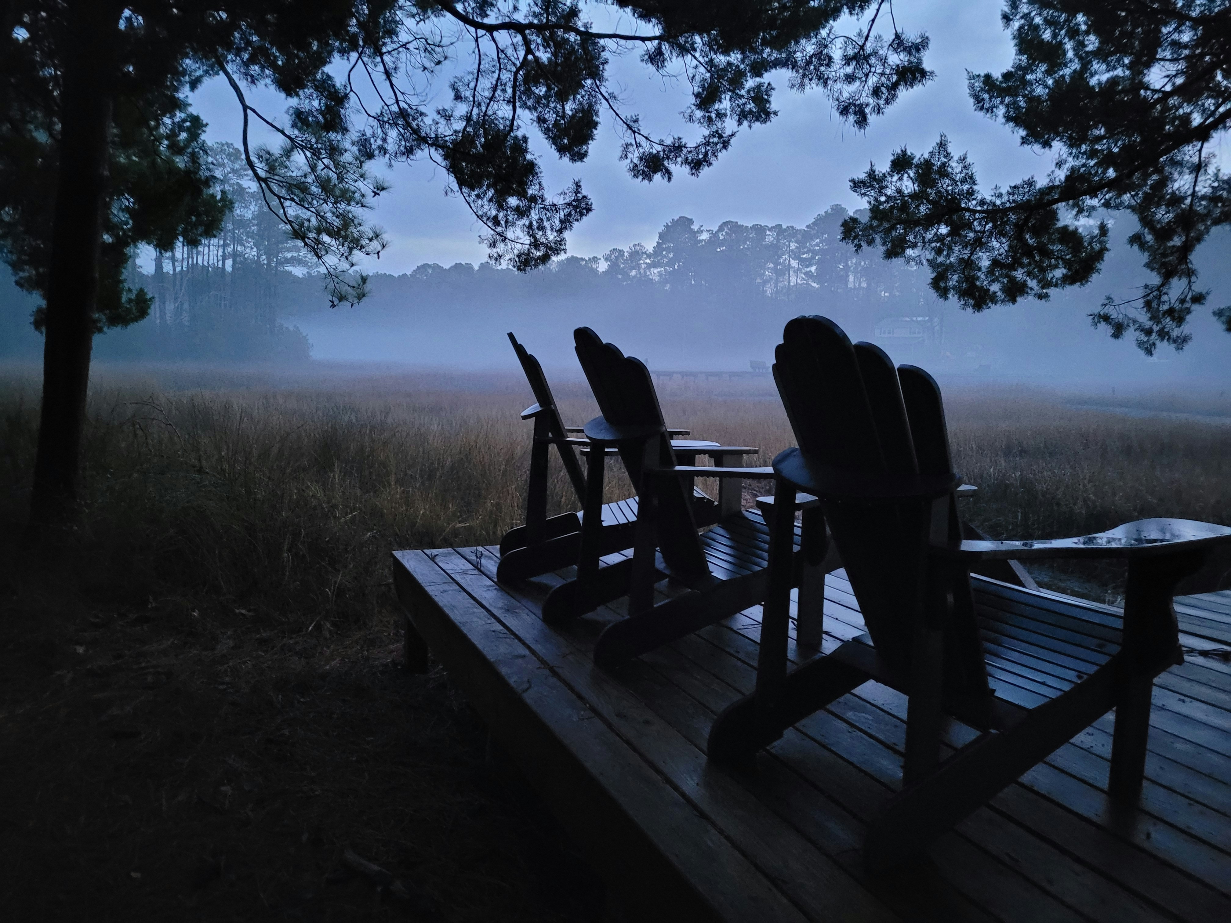 A group of chairs sitting on top of a wooden deck