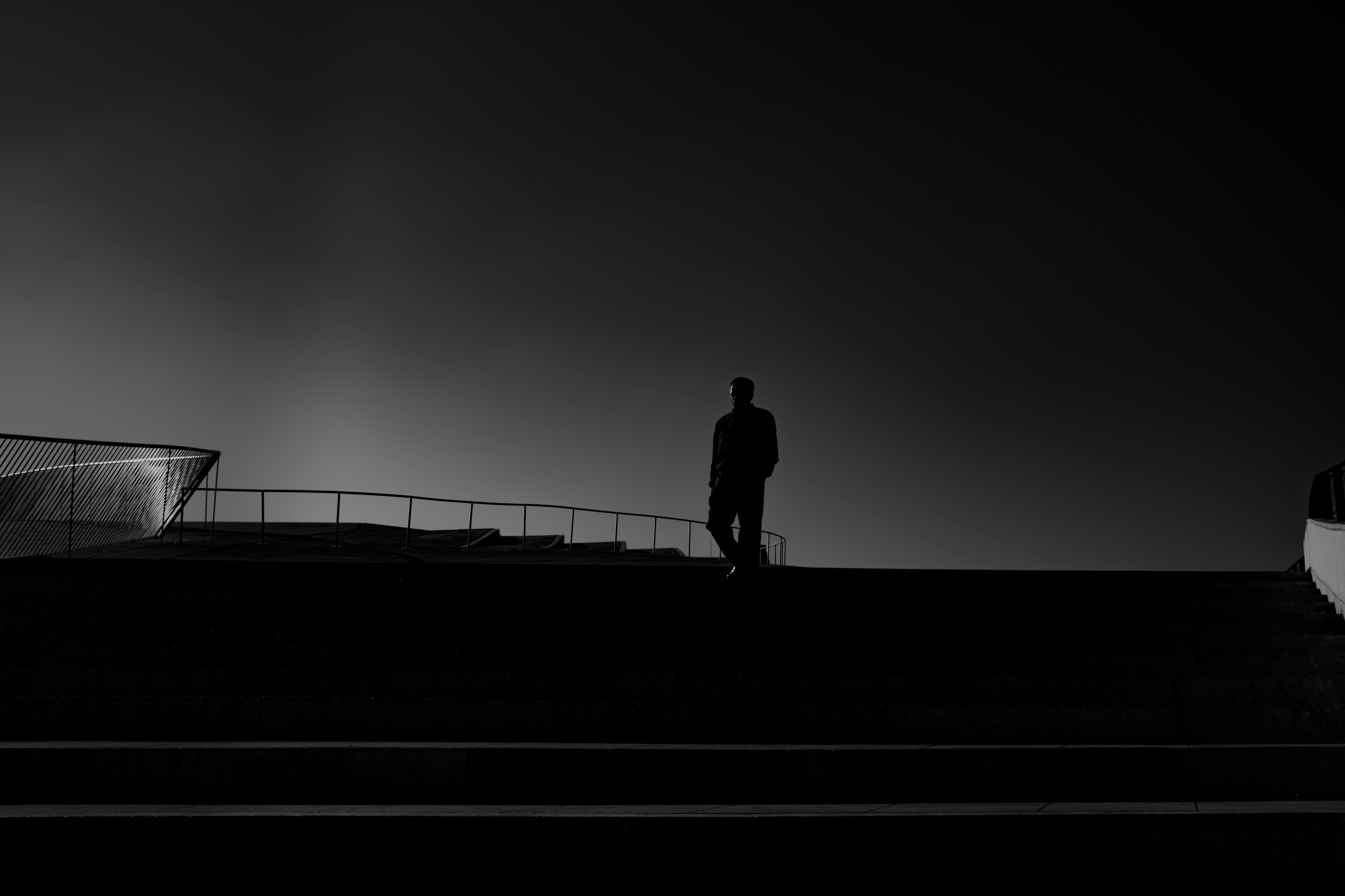 A man standing on top of a roof next to a building