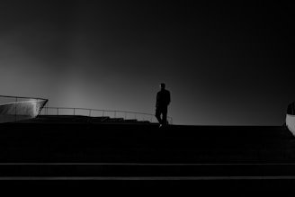 A man standing on top of a roof next to a building