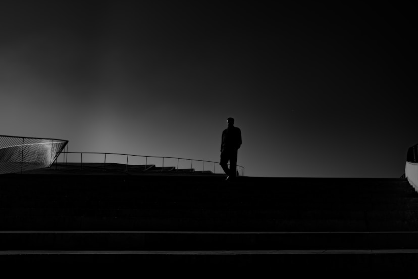 A man standing on top of a roof next to a building
