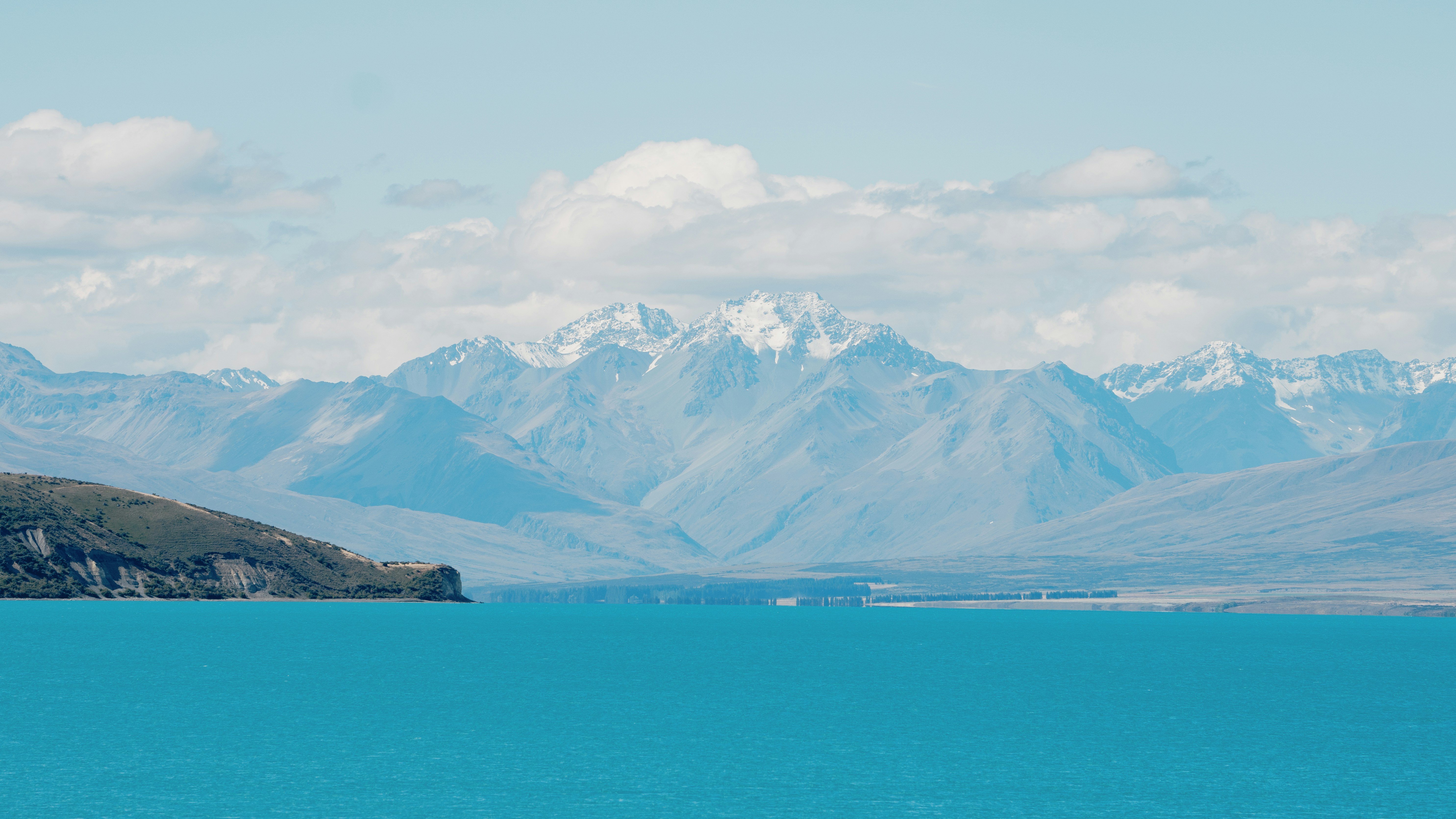 A large body of water with mountains in the background