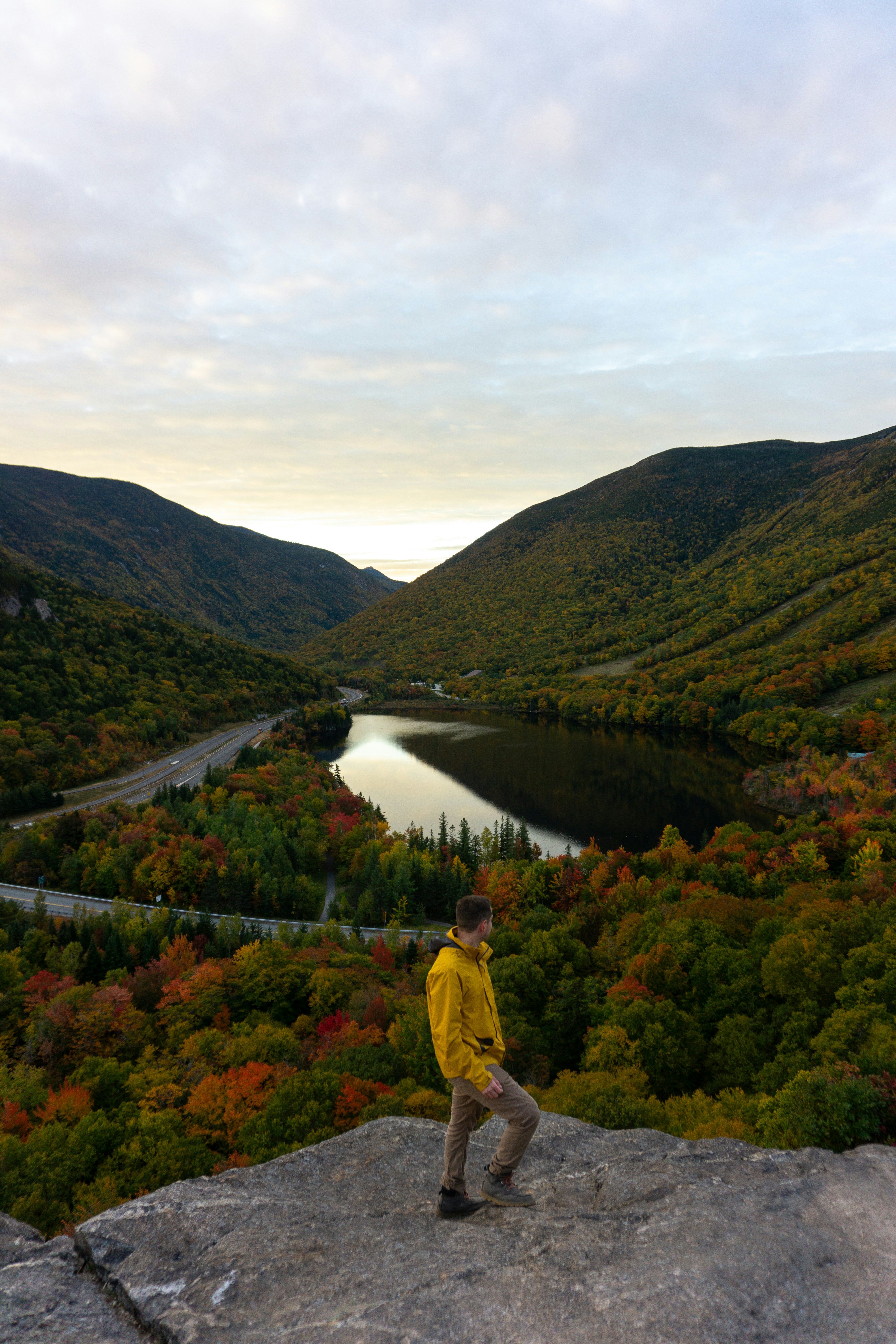 A man standing on top of a large rock