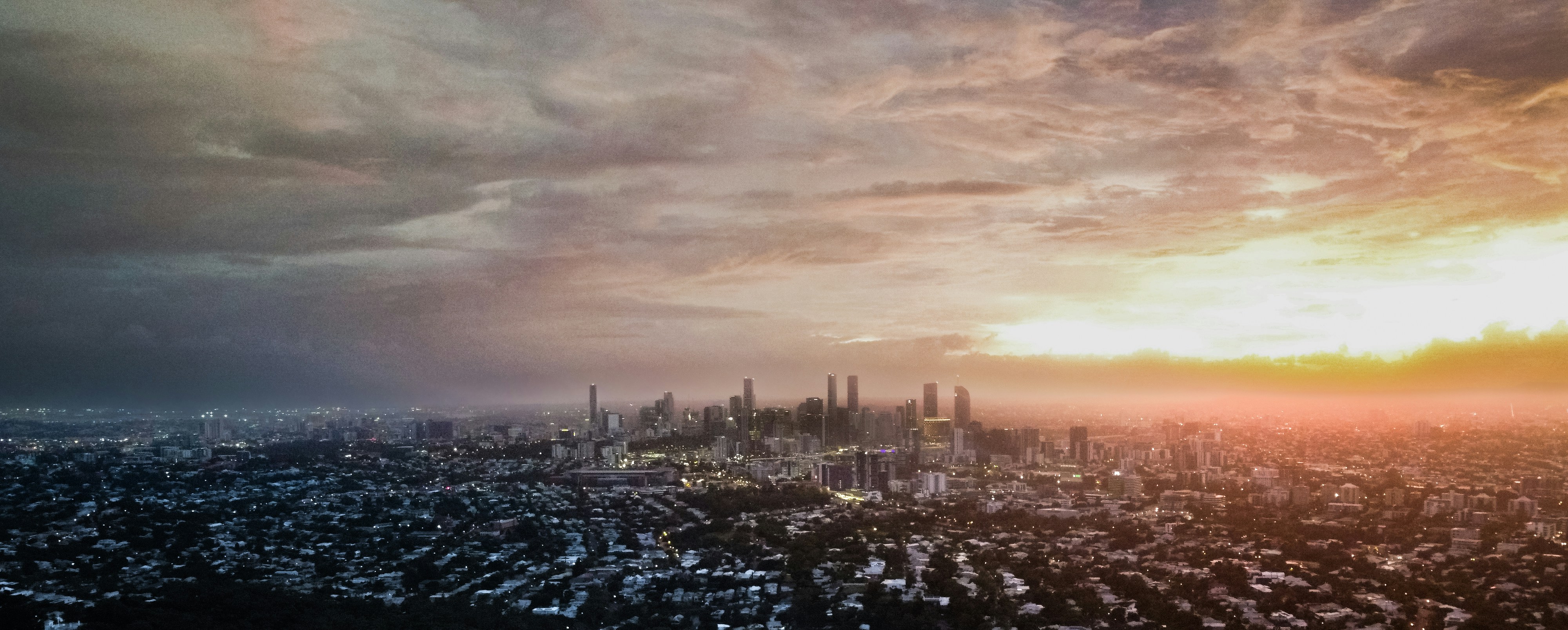 A view of a city at sunset from a plane