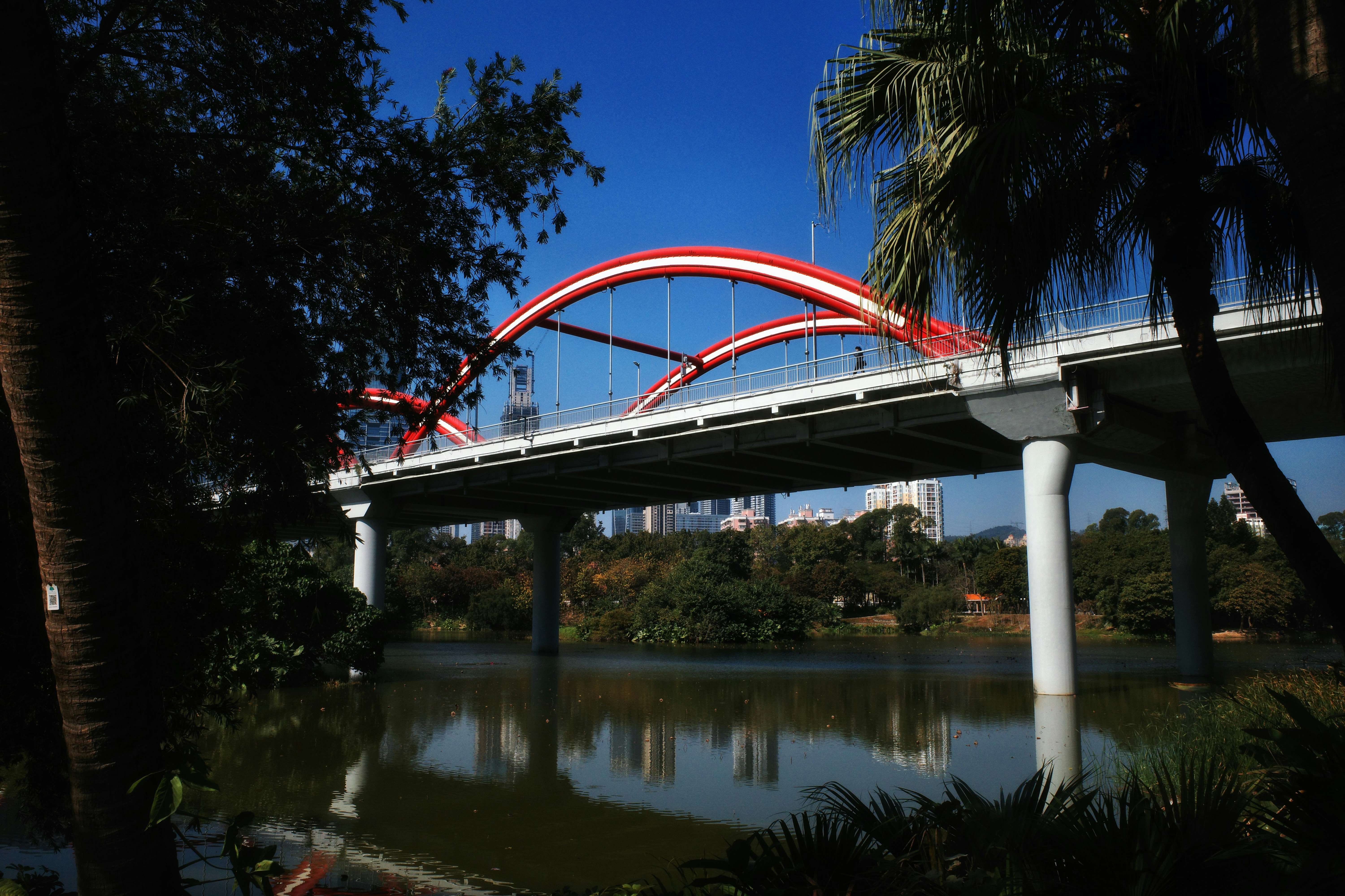 A red and white bridge over a body of water